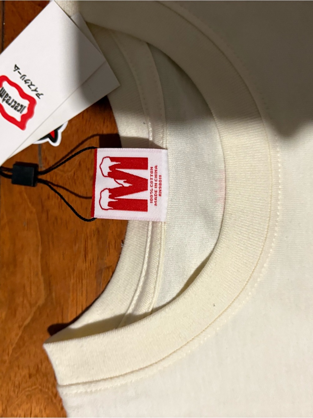 Mishka Cream Tee with Red Logo Tag